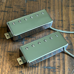 Two chrome mini-humbucker Brickhouse Toneworks guitar pickups displayed on a dark wood background.