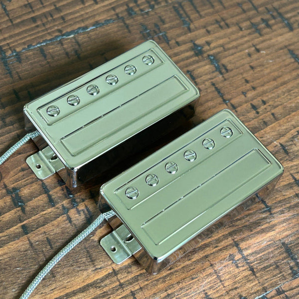 Brickhouse Toneworks nickel-covered humbucker pickup set — neck and bridge pair with slotted adjustment screws and braided leads on aged wood