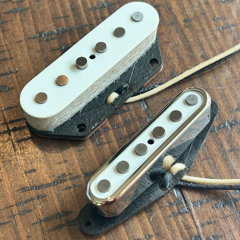 Brickhouse Toneworks white top Telecaster pickup set - neck and bridge with alnico poles on wood surface